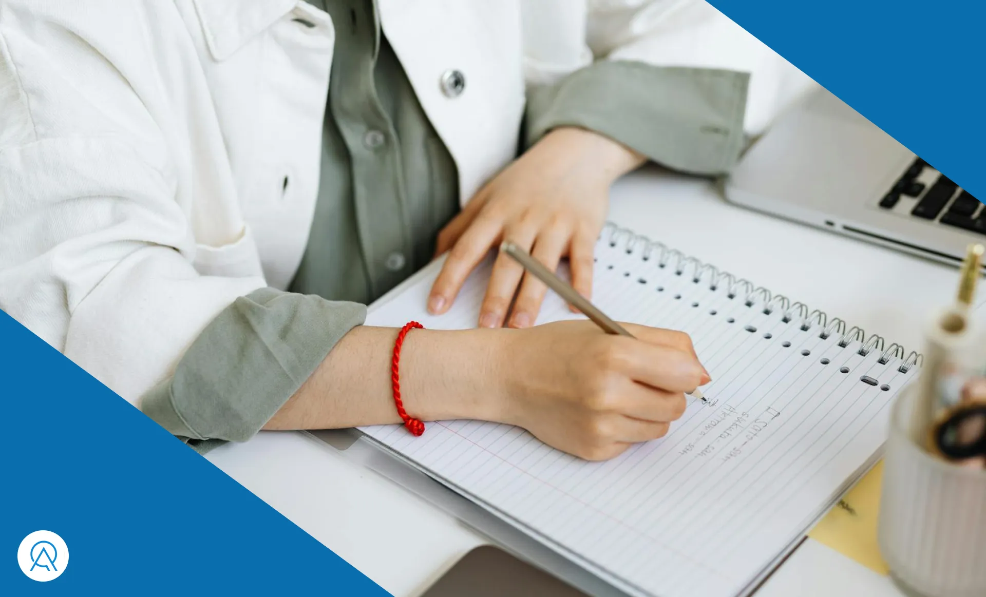 Chiropractor taking notes over a desk with a computer